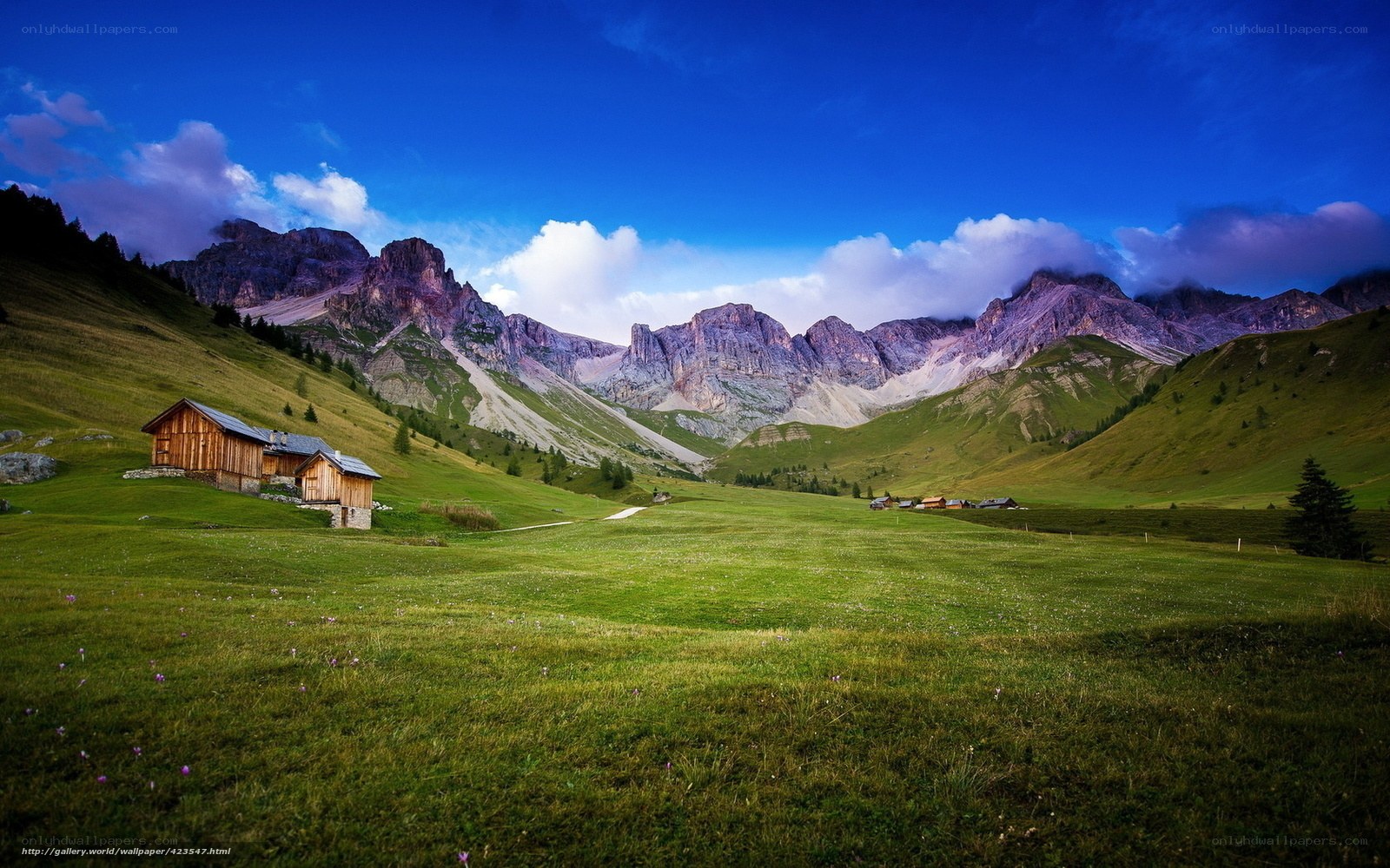 Mountain valley with wooden cabins