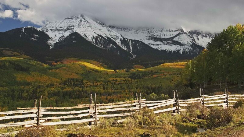 Mountain valley with wooden fence