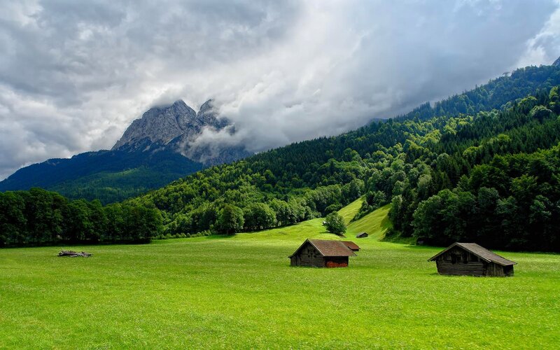 Mountain valley with wooden huts