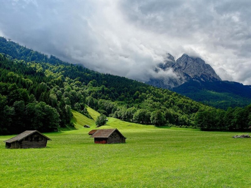 Mountain valley with wooden huts