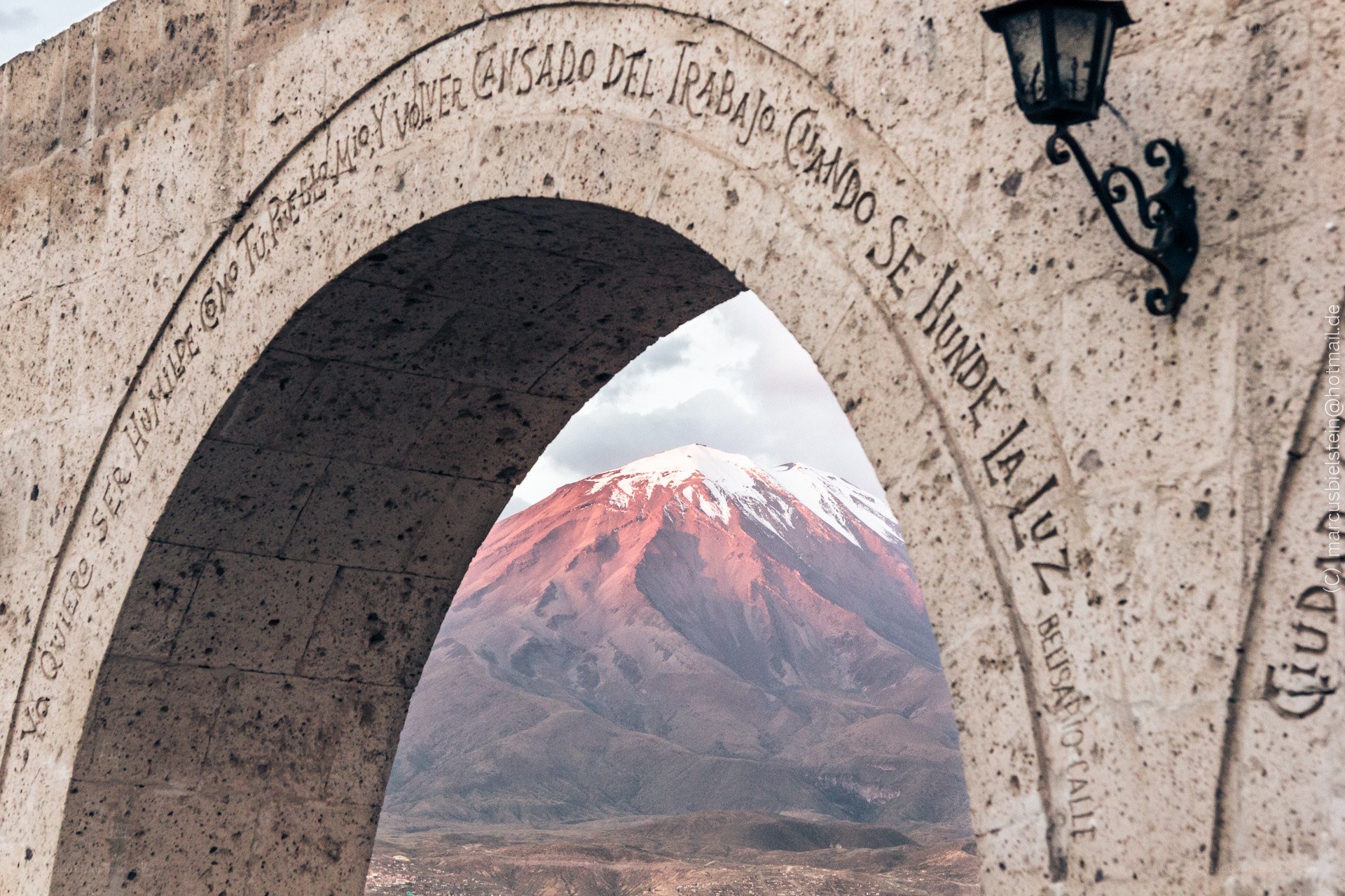 Mountain view through stone arch