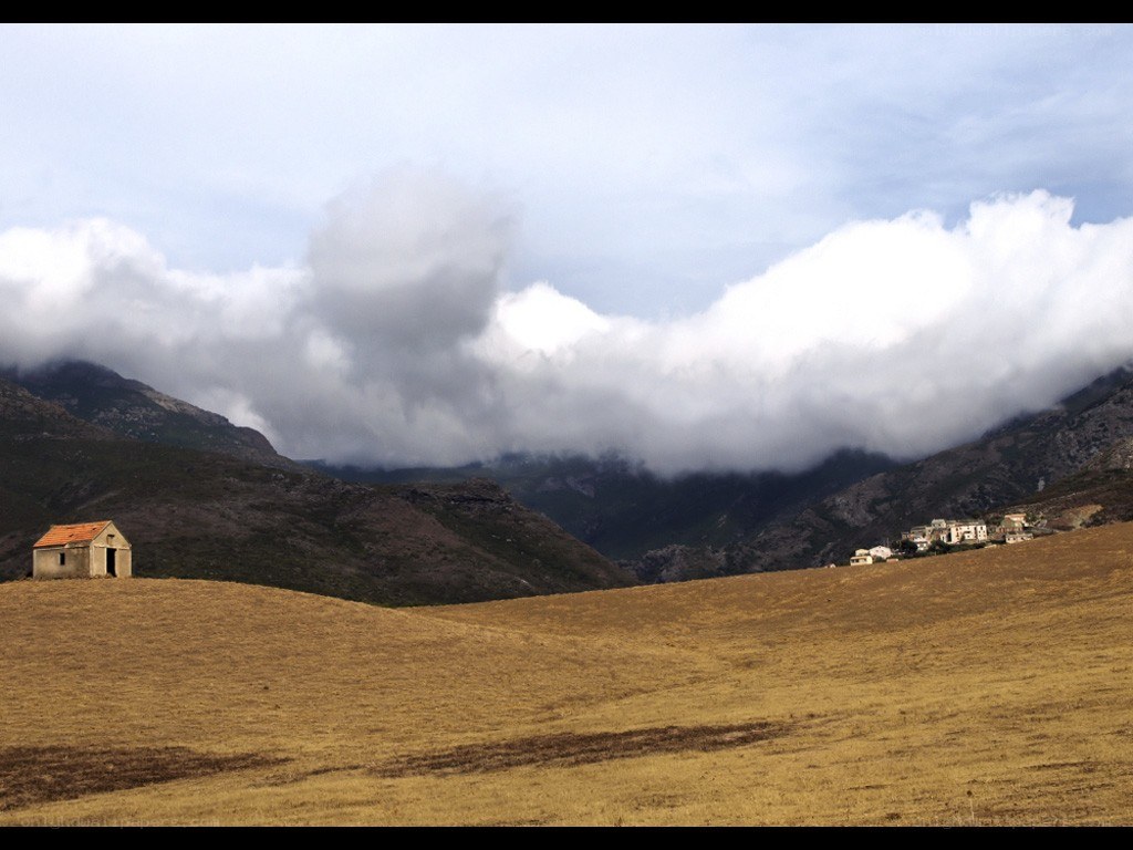 Mountain village under cloudy sky