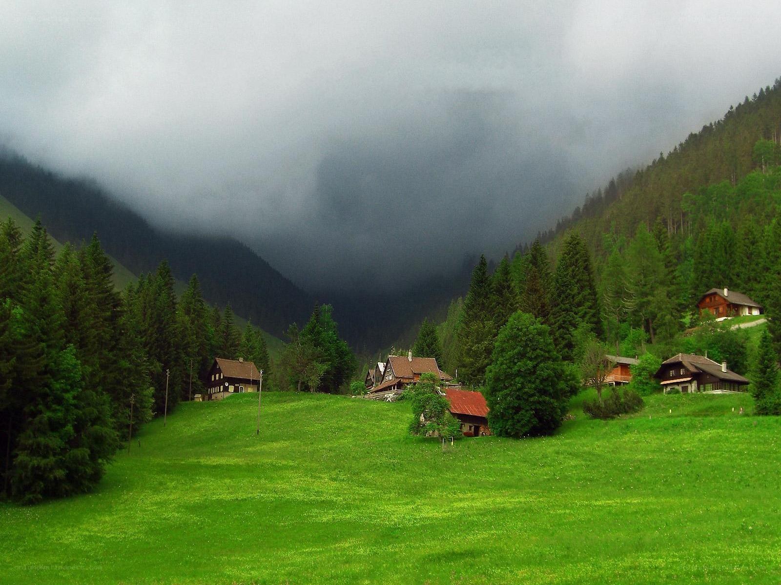 Mountain village under cloudy sky