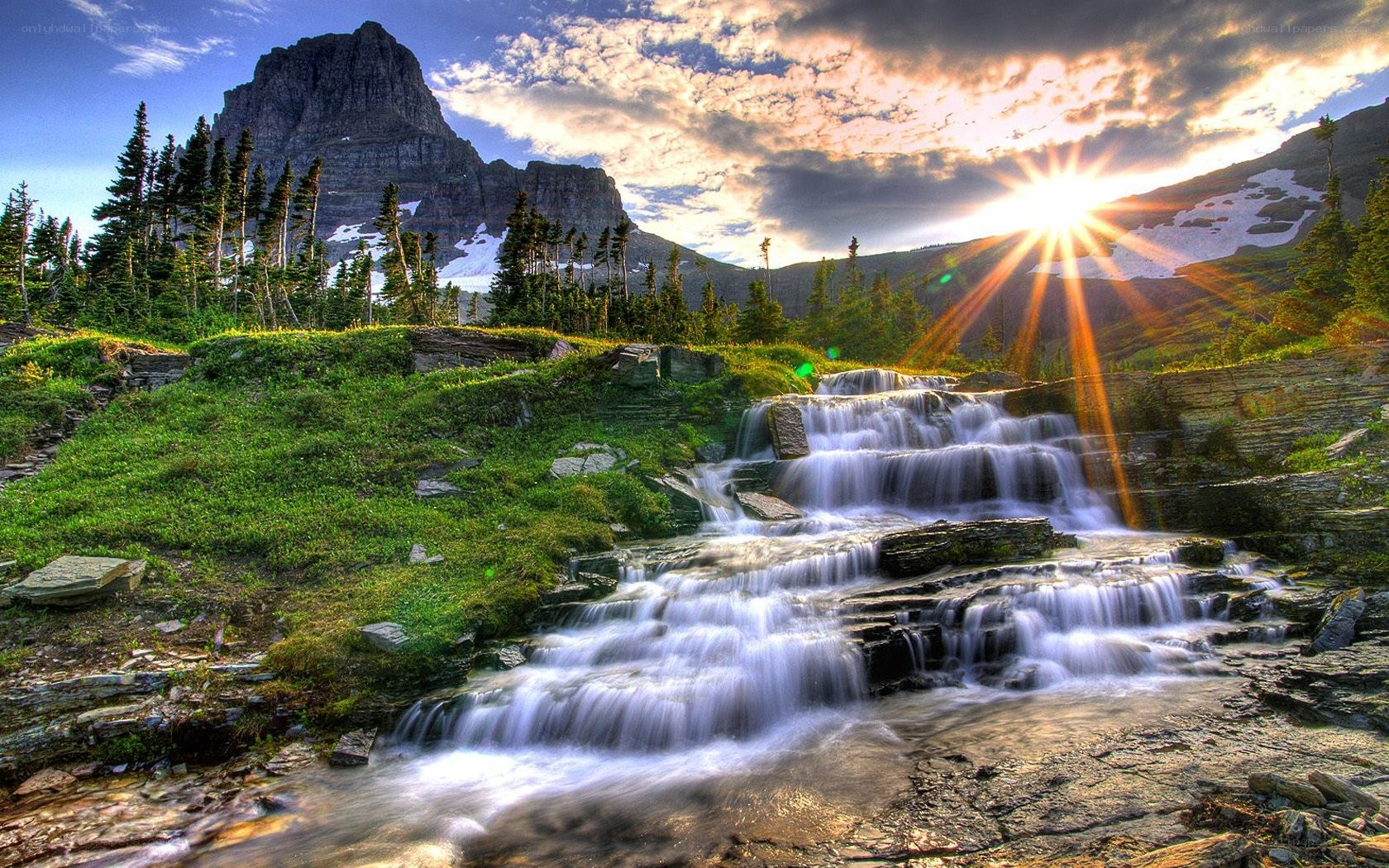 Mountain waterfall at sunset