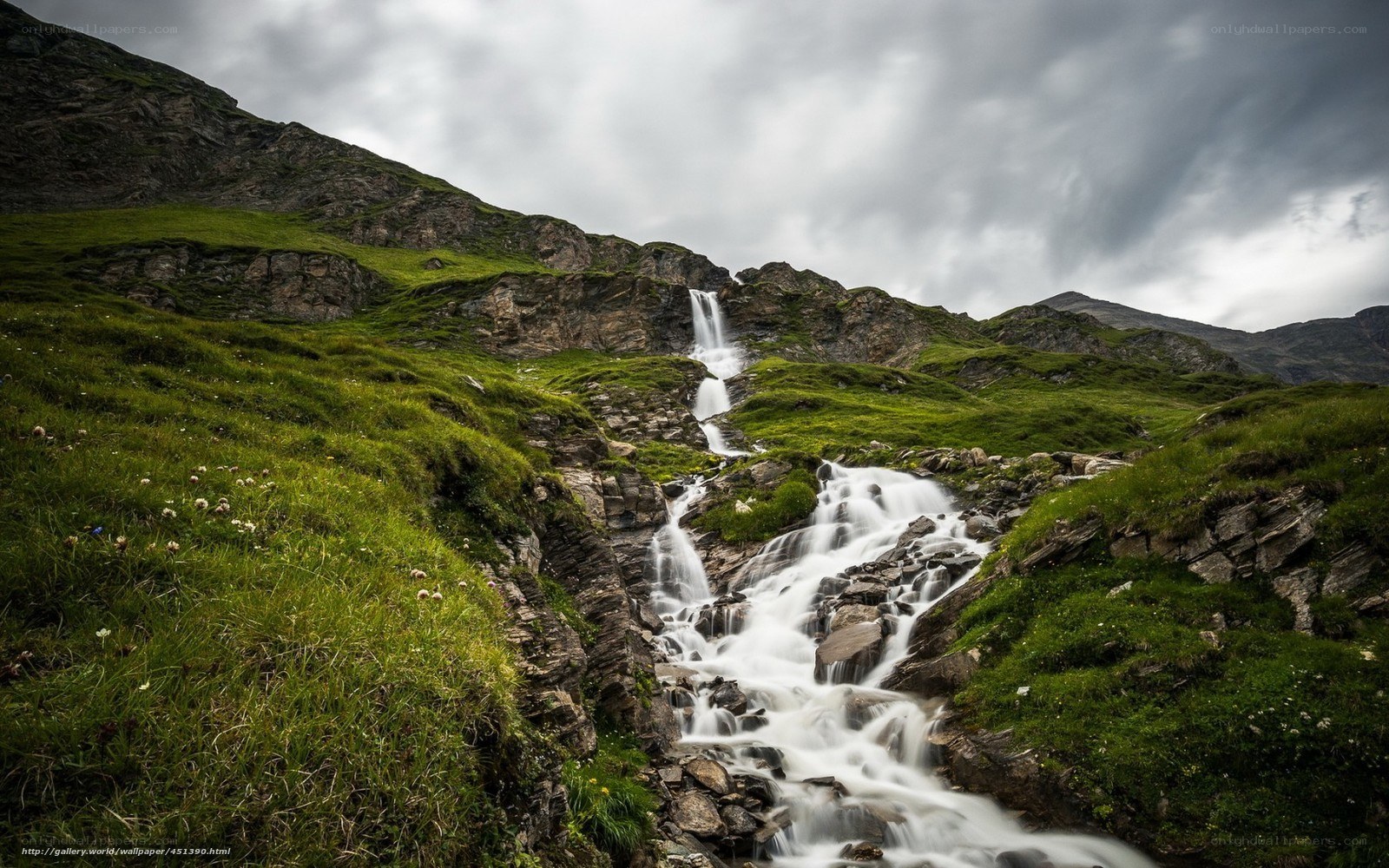 Mountain waterfall in green valley