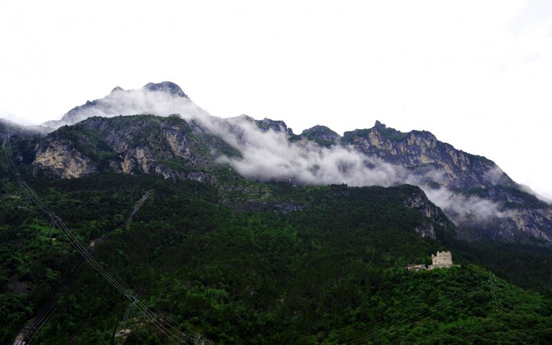 Mountain with clouds and tower