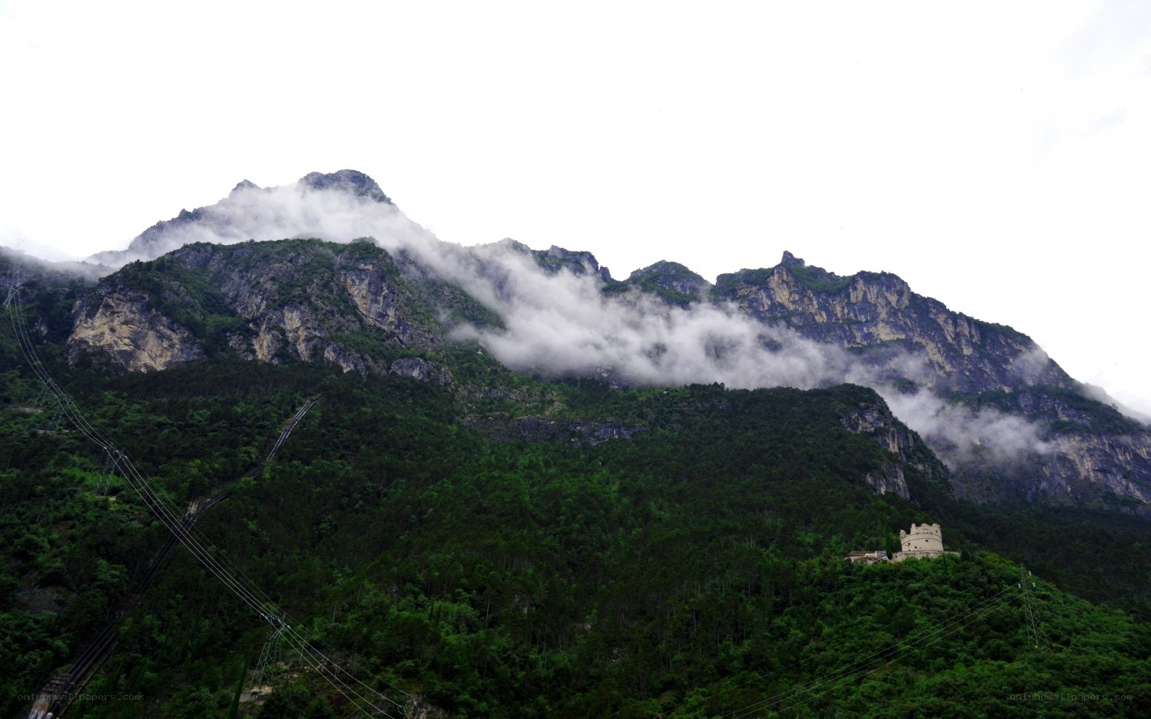 Mountain with clouds and tower