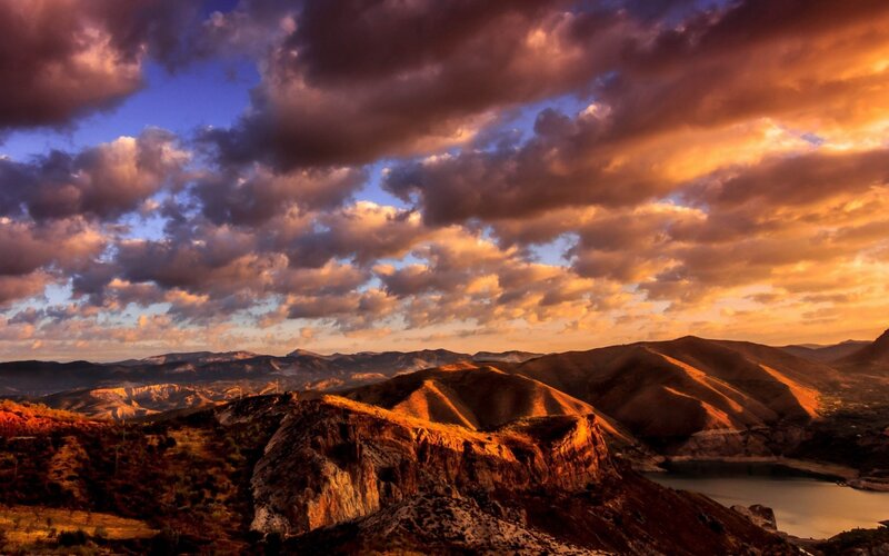 Mountainous Landscape at Sunset — Orange, Dramatic, Photograph, Clouds