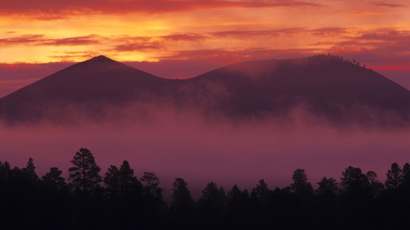 mountains at sunrise with fog