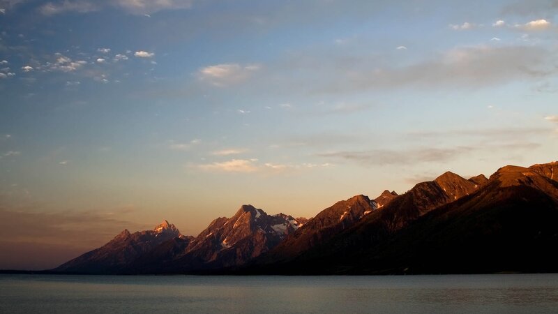 mountains at sunset by a lake