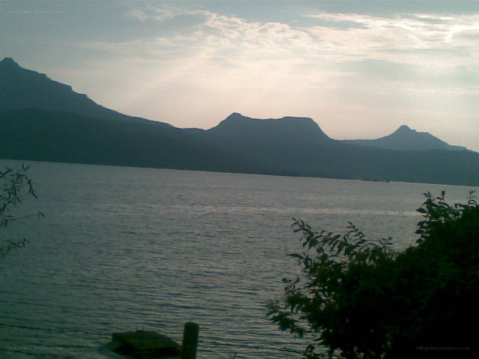 mountains over a lake at dusk