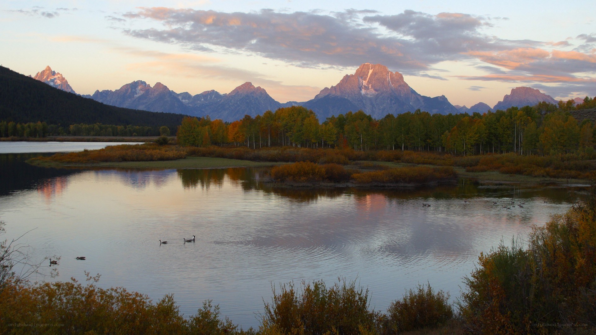 mountains reflected in a lake at sunset