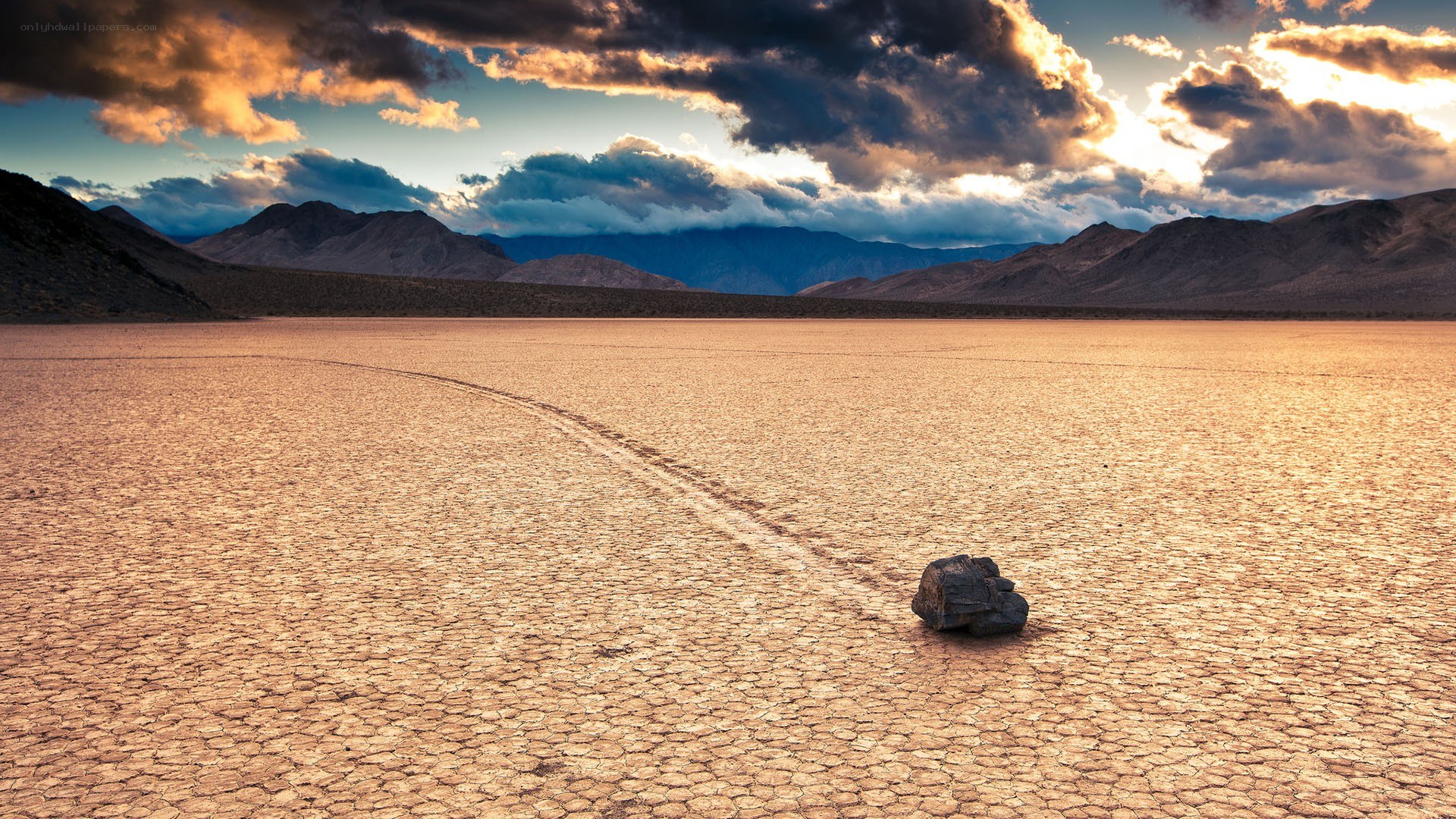 Moving rock on dry lake bed