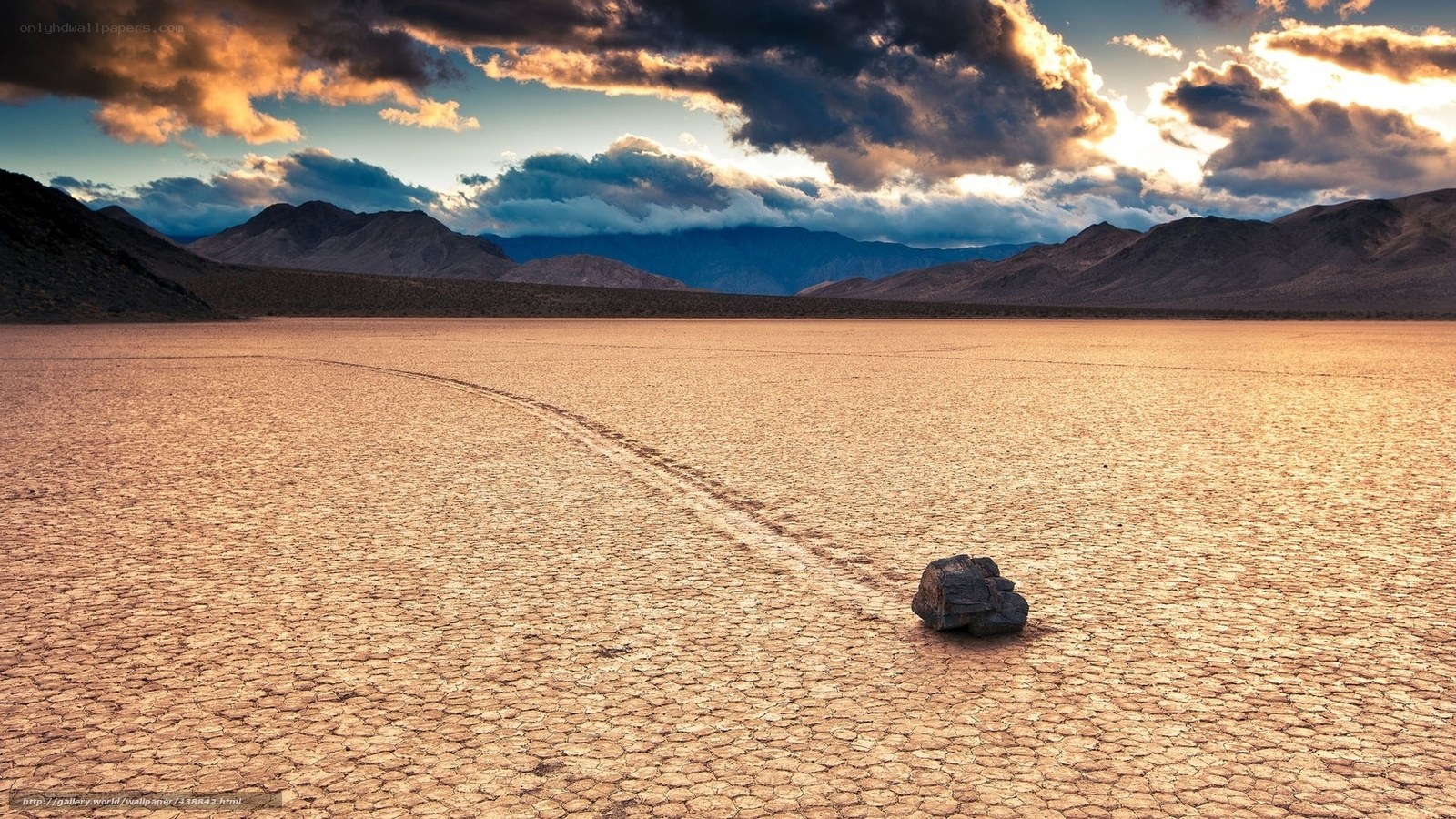Moving rock on dry lake bed