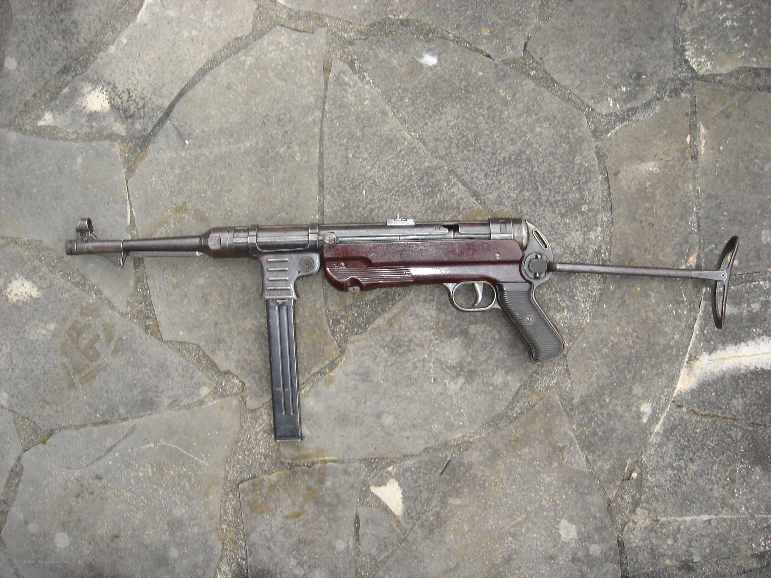 MP40 submachine gun on stone