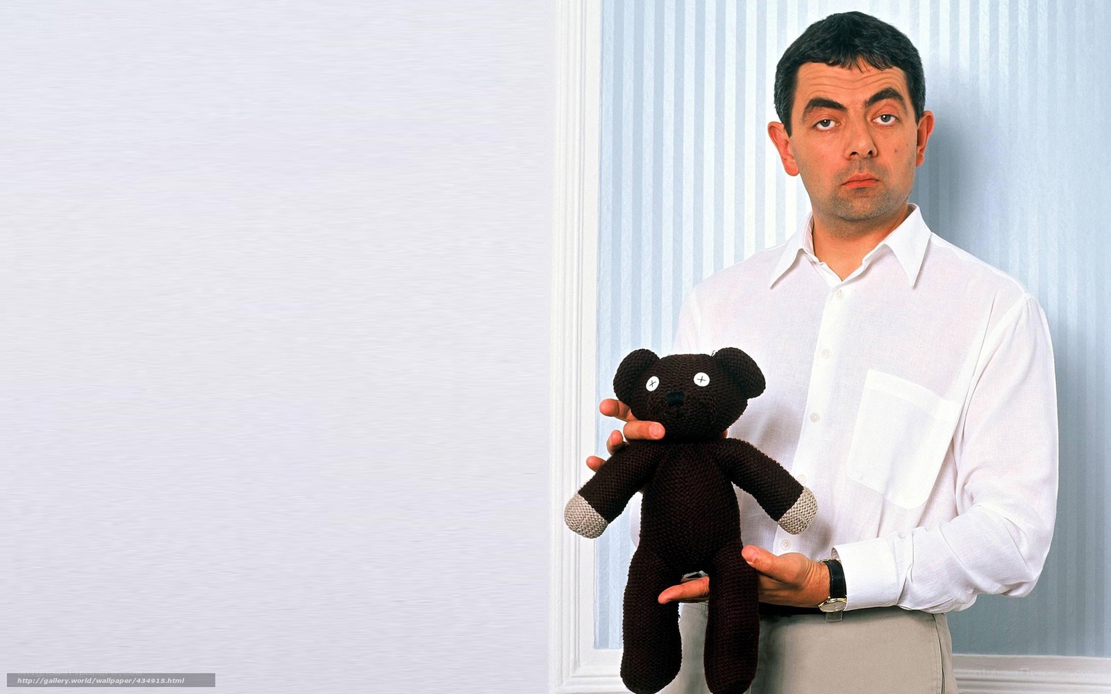 Mr. Bean holding a teddy bear