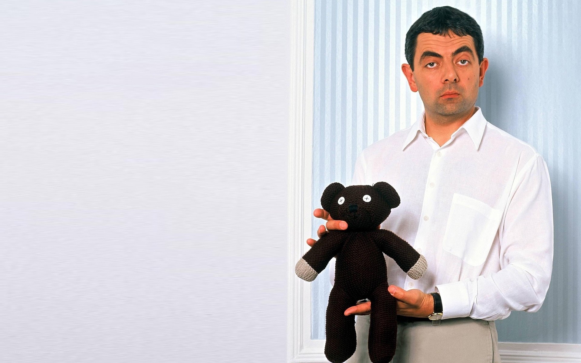 Mr. Bean holding a teddy bear