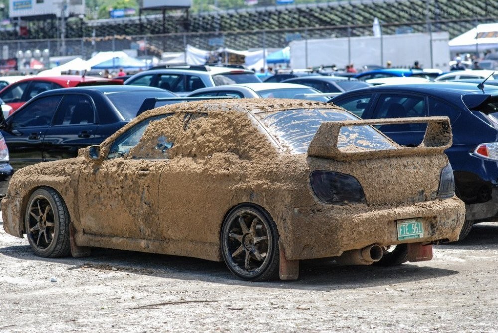 muddy car at a race event