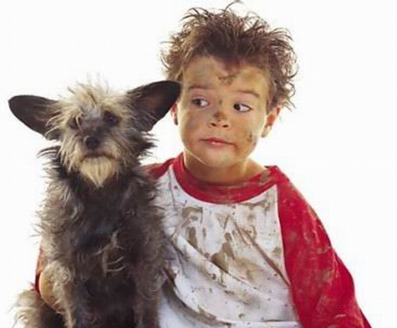 Muddy Child Holding Dog