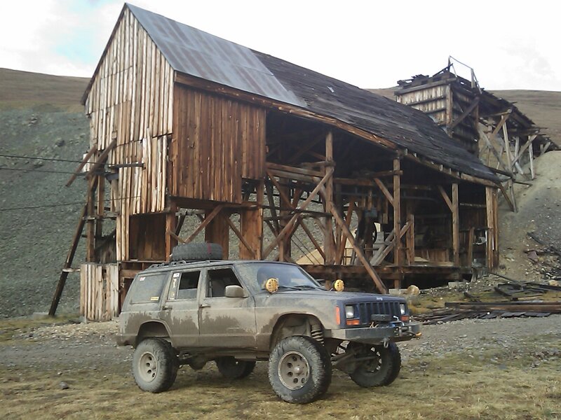 Muddy Jeep in Front of Building