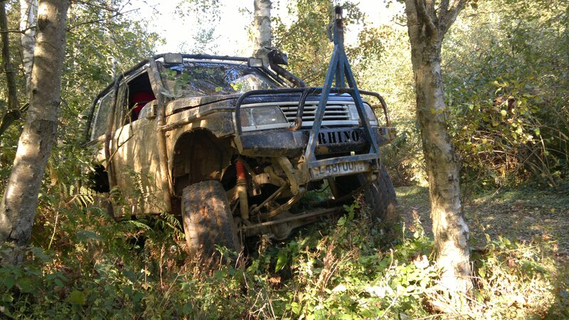 muddy off-road vehicle in forest