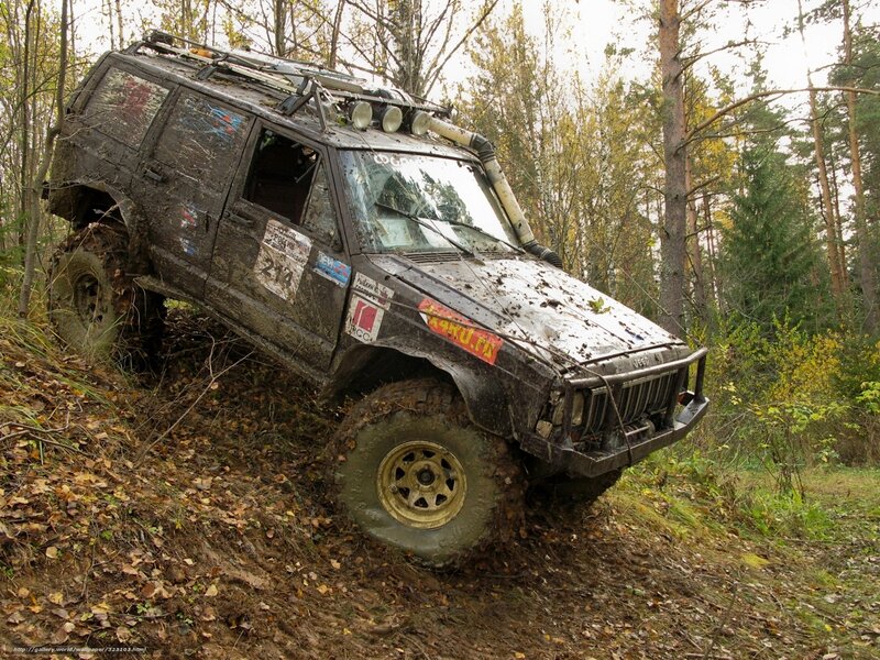 Muddy off-road vehicle in forest