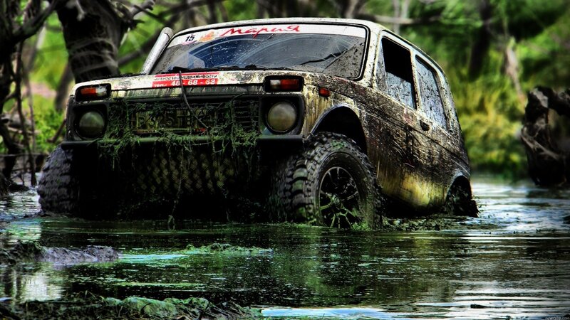 muddy off-road vehicle in swamp