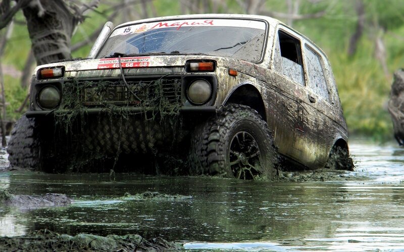 muddy off-road vehicle in water