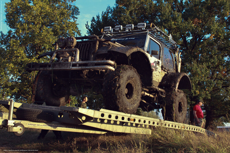 Muddy off-road vehicle on trailer