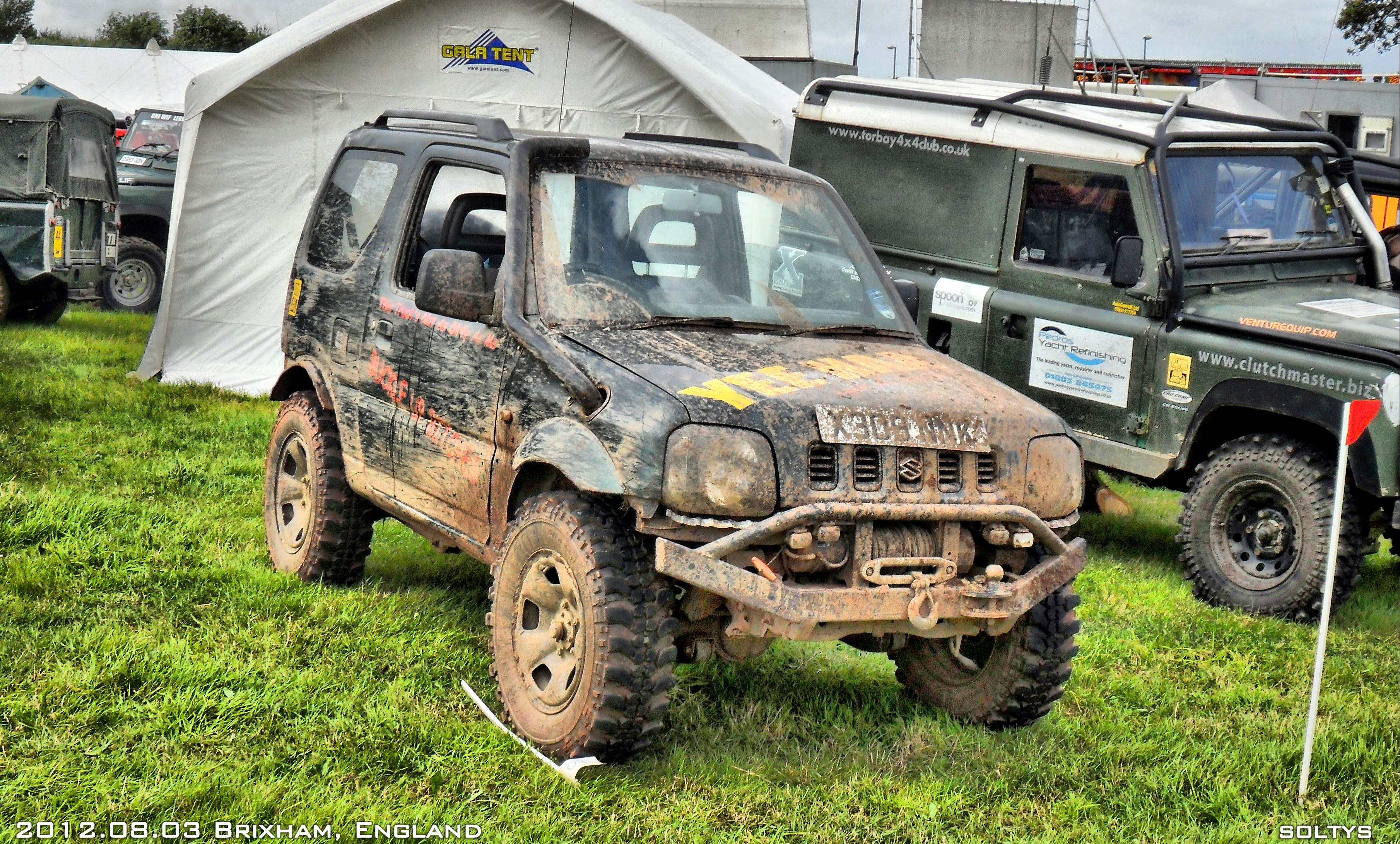 Muddy off-road vehicles at event