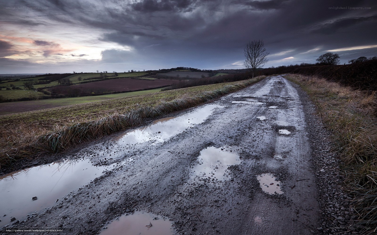 Muddy road under stormy sky