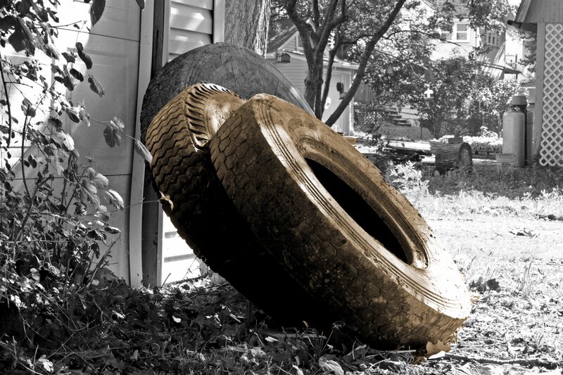 Muddy Tires Leaning Against House