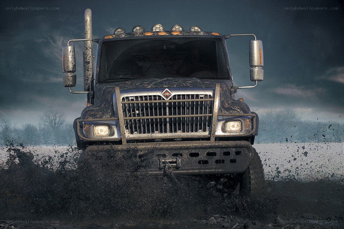 Muddy truck driving through mud