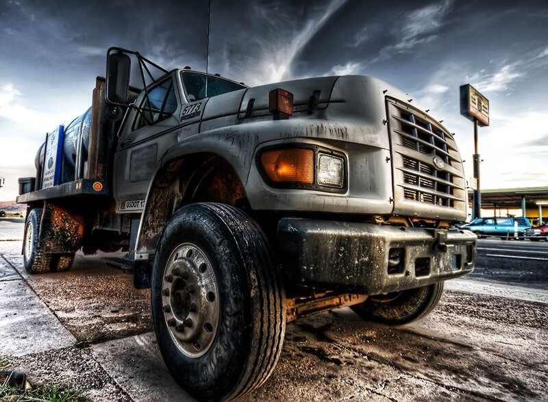 muddy utility truck at gas station