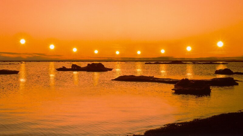 Multiple suns over water