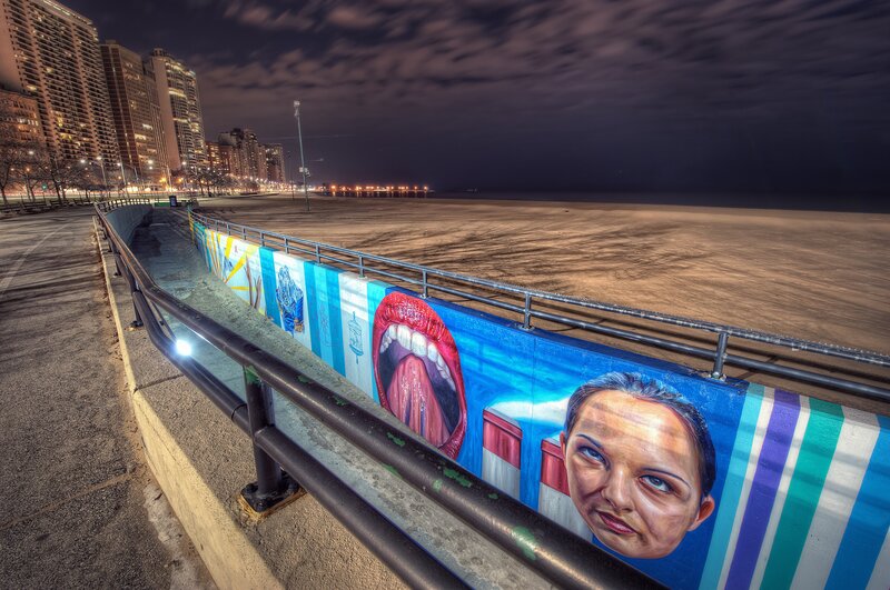 Mural art along a city beach at night