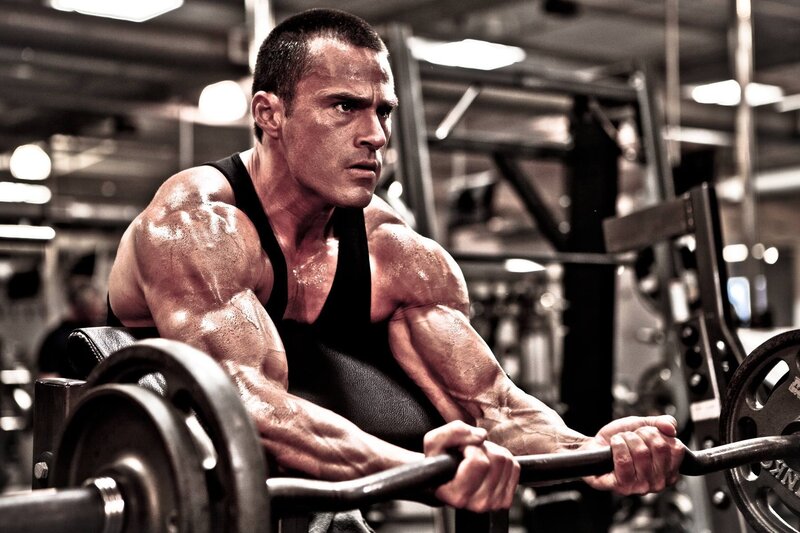 muscular man lifting weights