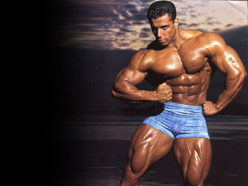 Muscular Man Posing — Brown, Dramatic, Photograph