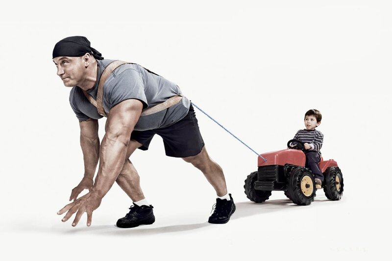 Muscular Man Pulling Toy Tractor