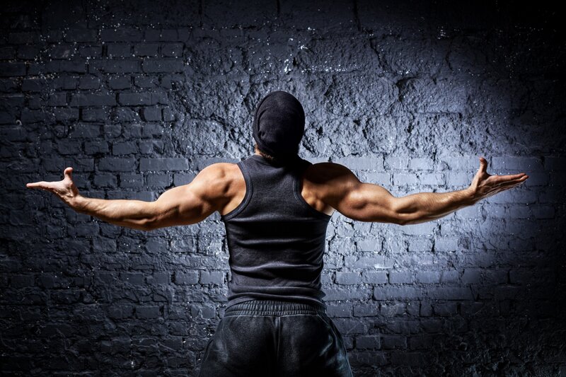 muscular man with arms outstretched