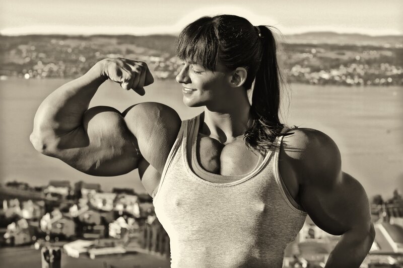 muscular woman flexing arms