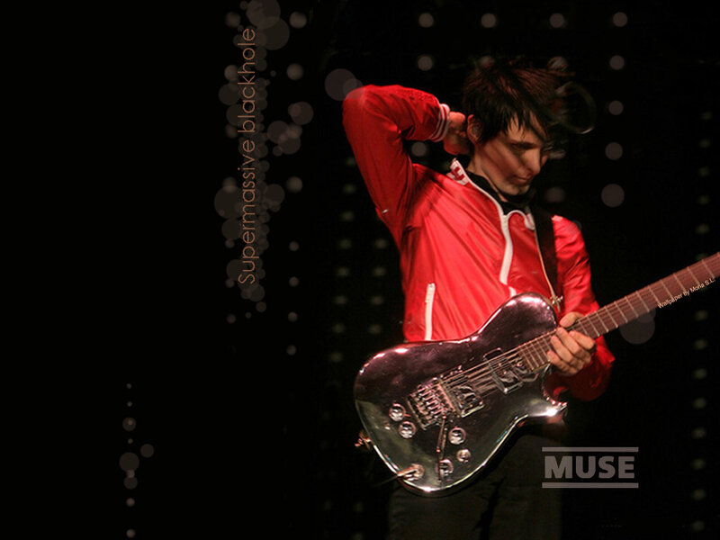 Muse guitarist performing on stage