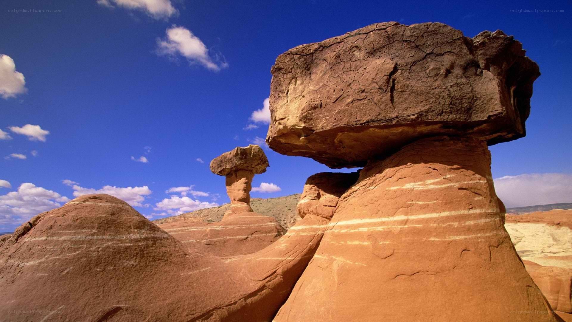 Mushroom rock formations under blue sky