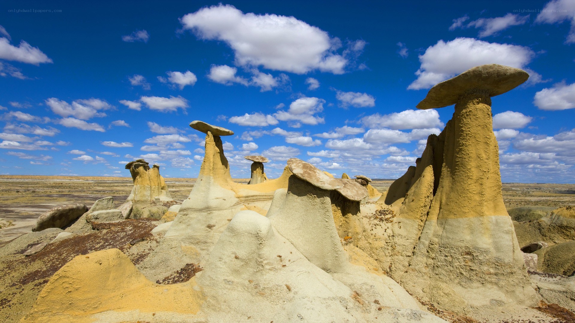 Mushroom rock formations under blue sky