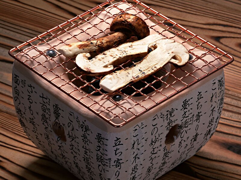 Mushrooms grilling on a ceramic stove