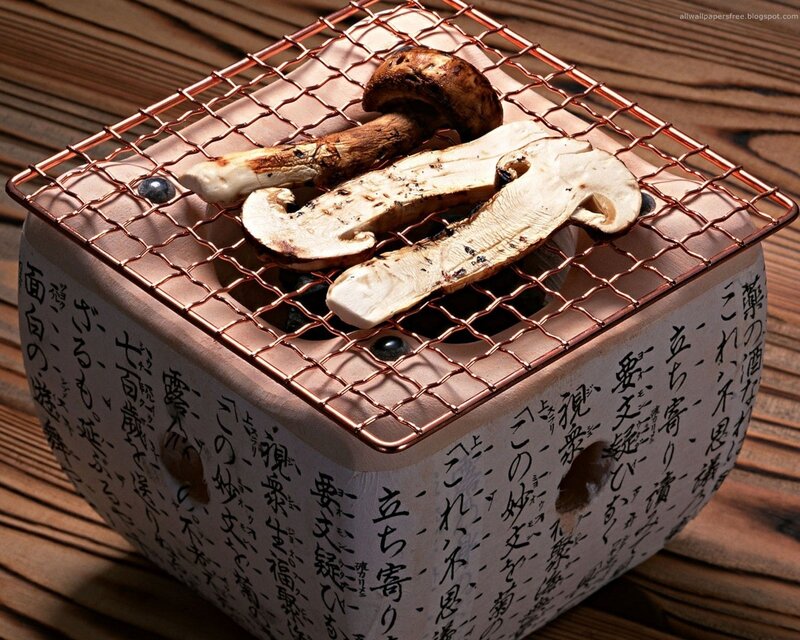Mushrooms grilling on a small stove