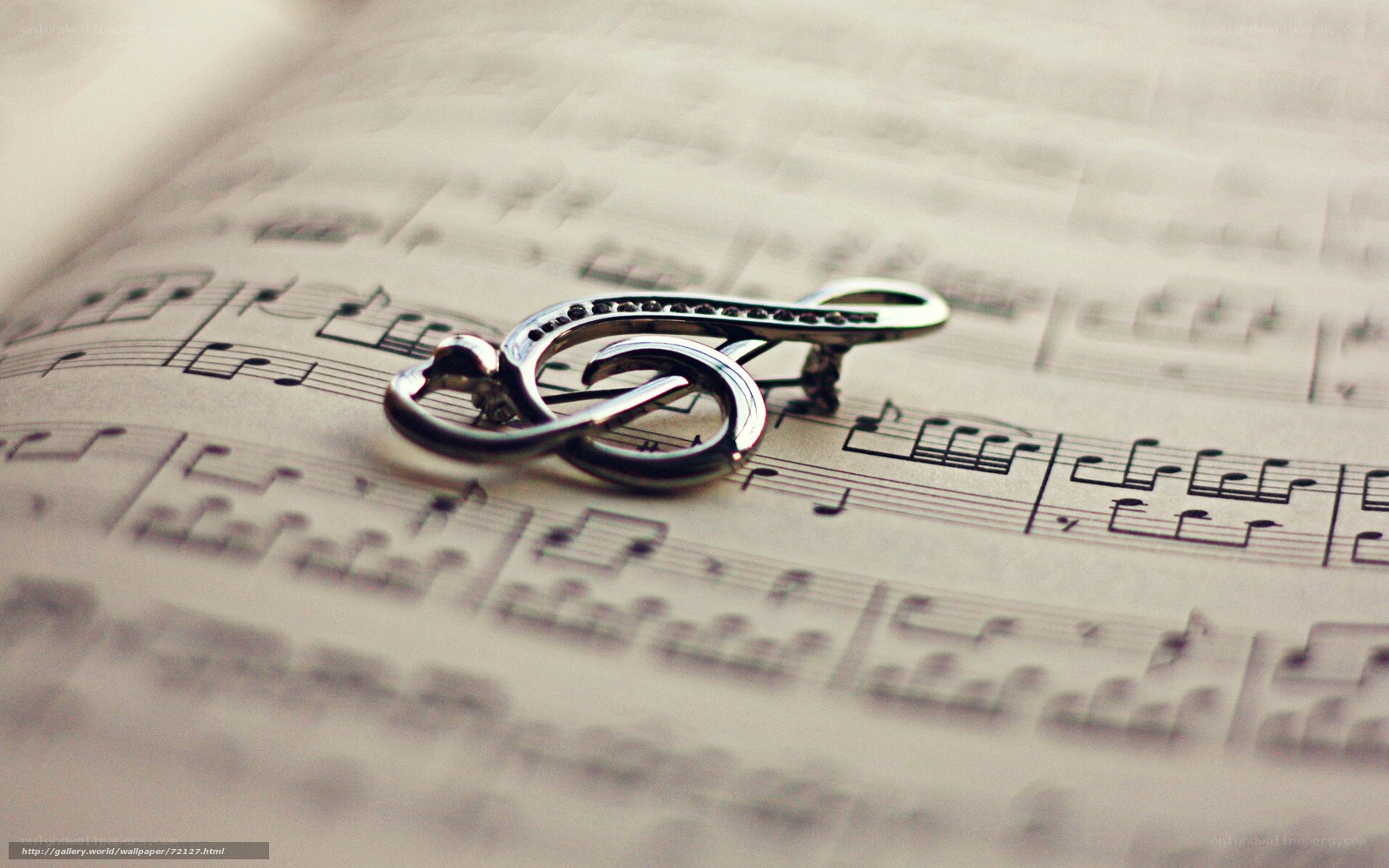 Music note brooch on sheet music