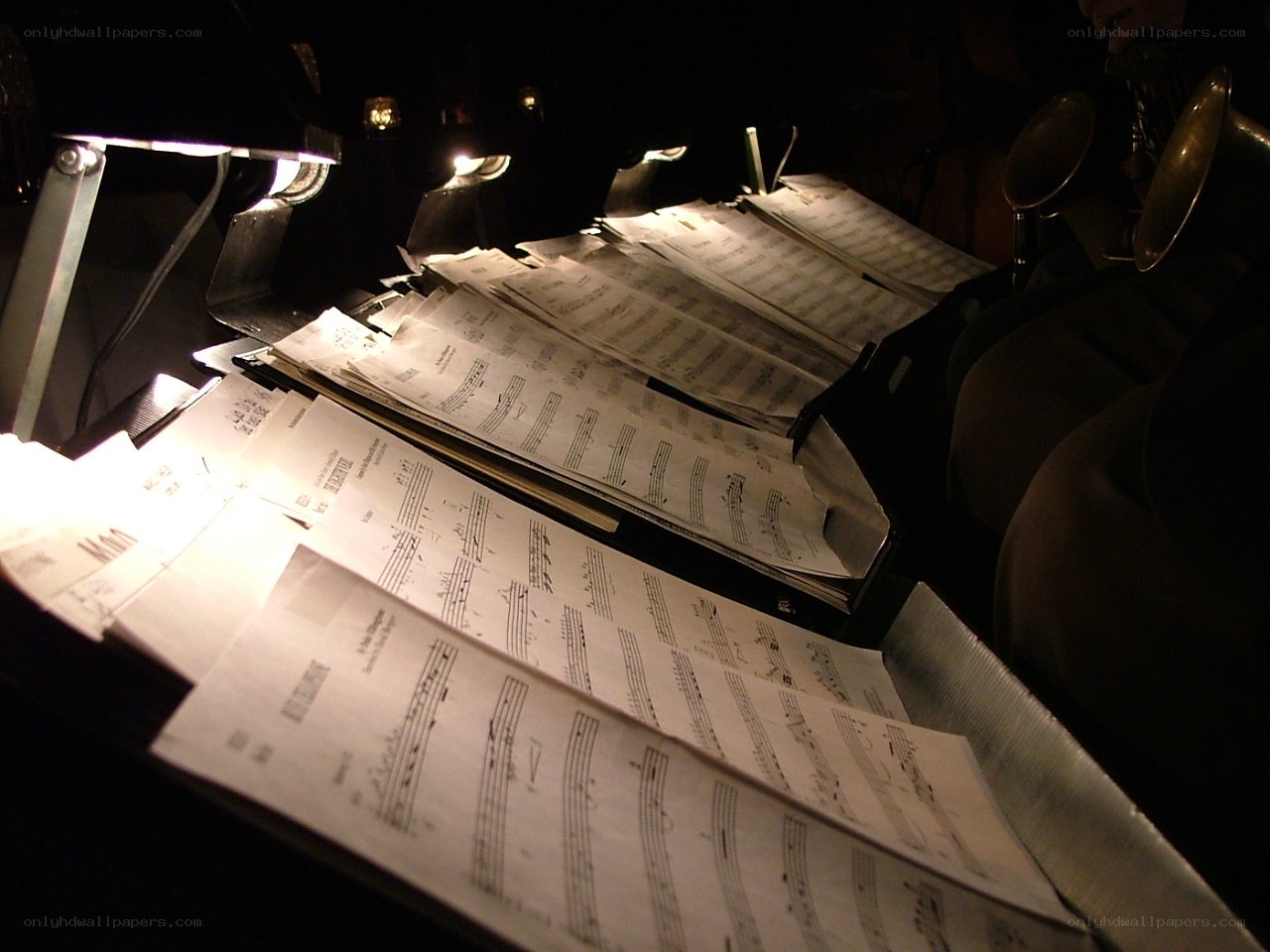 Music sheets on stands in dim light