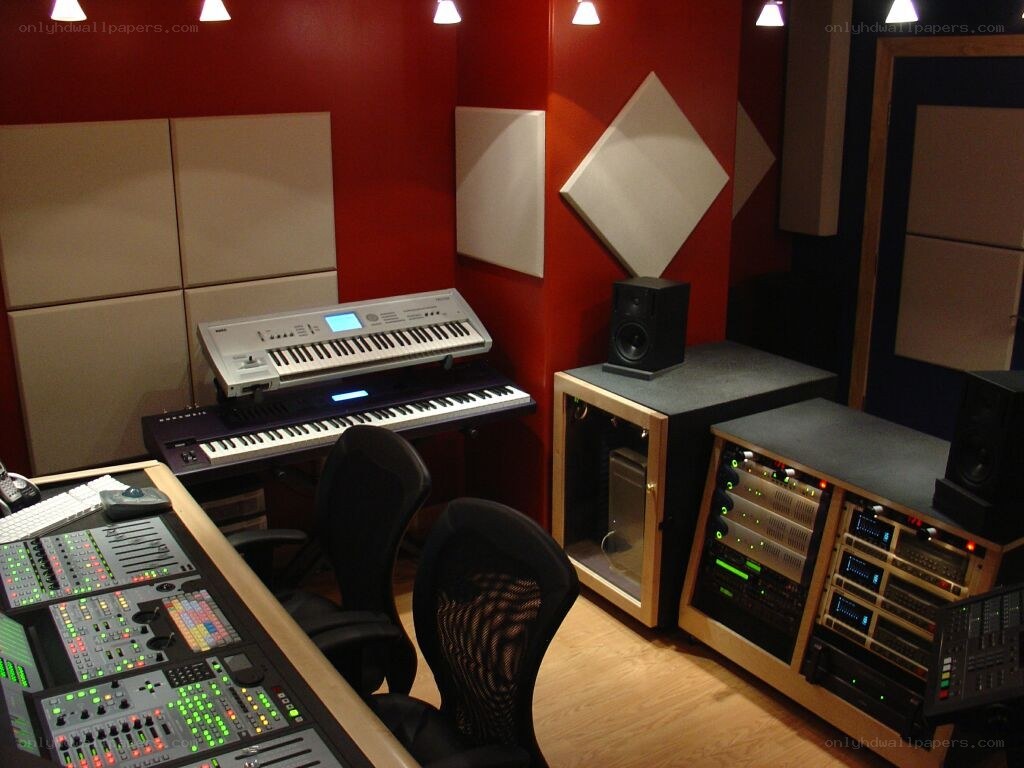 music studio with keyboards and mixing console