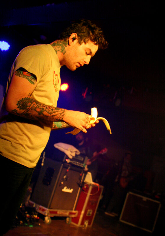 Musician eating banana on stage